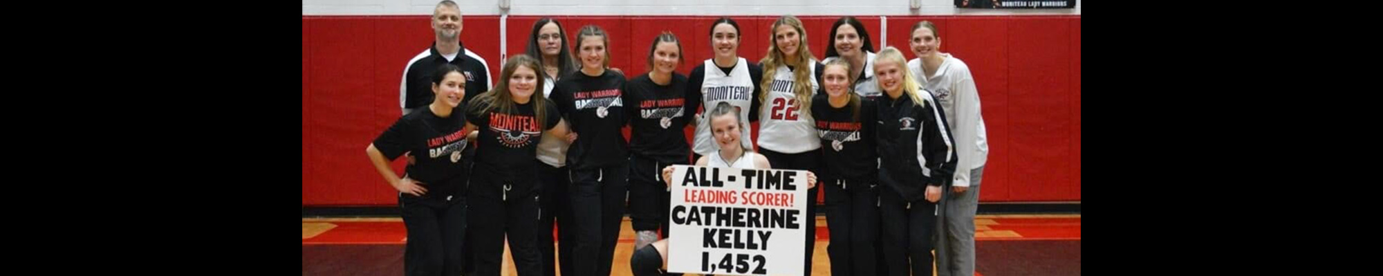 Girls basketball team celebrating teammate, Catherine as 