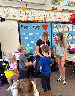 Young students with their teachers in a classroom