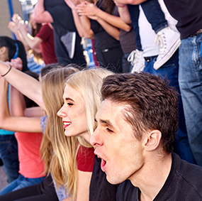 Students cheer on team from bleachers