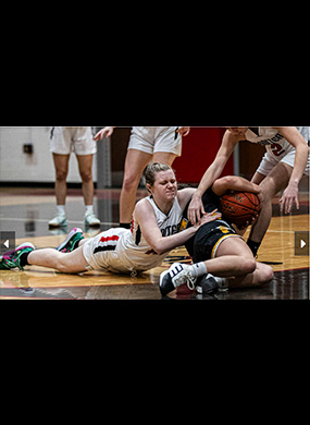 Players fighting for posession of basketball