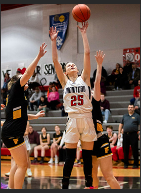 Players reaching for the basketball
