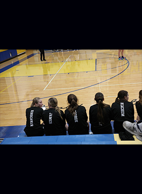 Girls basketball team sitting on a bench