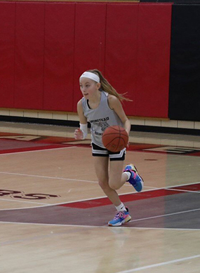 Female basketball player dribbling the ball during a game