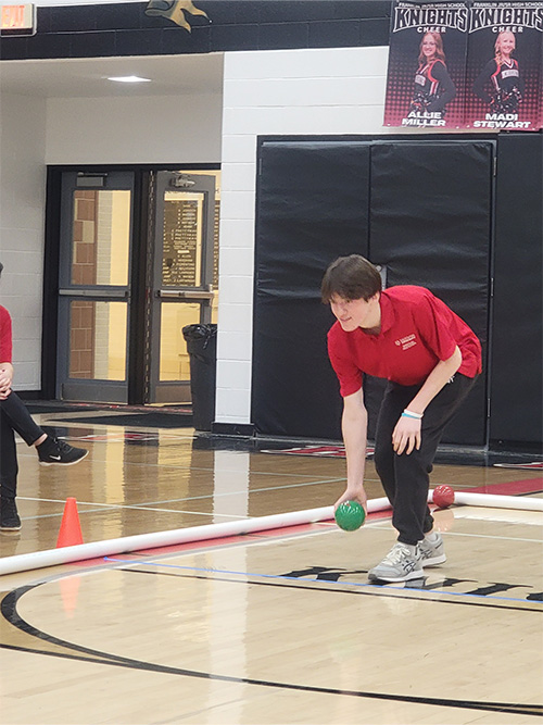 Player preparing to roll ball on the court