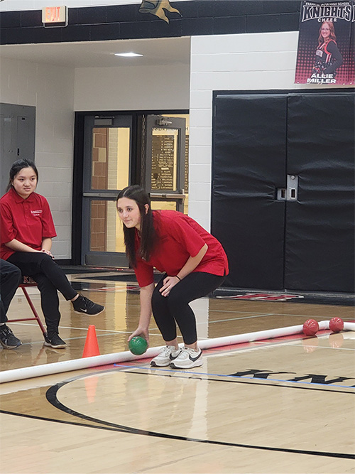 Girl preparing to roll bocce ball