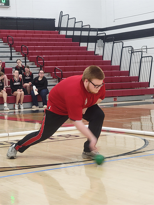 Boy on the court playing bocce ball